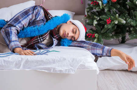 Man suffering hangover after christmas partyの写真素材