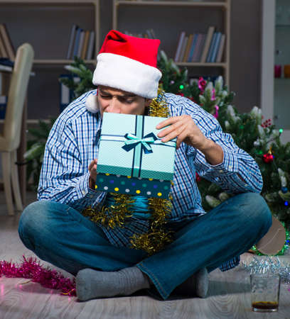 Man celebrating christmas at home aloneの写真素材