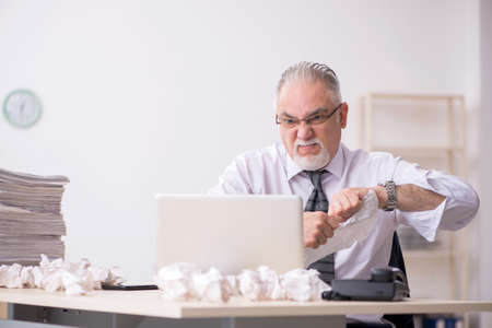 Old male employee in brainstorming concept