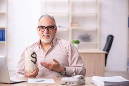 Old male employee in remuneration conceptの写真素材