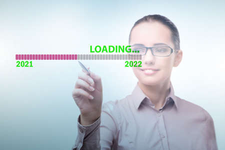 Businesswoman pressing virtual button with year 2022の写真素材