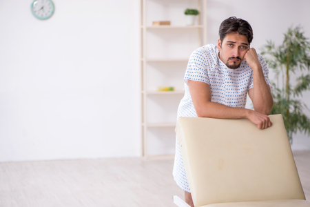Young male patient waiting for doctor at the hospitalの写真素材