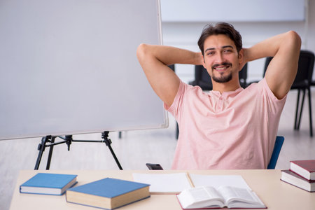 Young male student preparing for exams in the classroomの写真素材