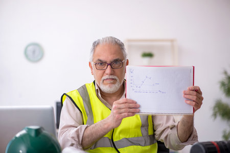 Old male architect working in the officeの写真素材