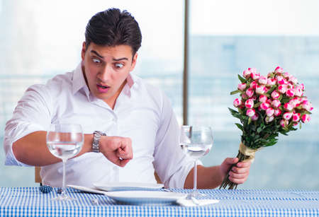 Handsome man alone in restaraunt on dateの写真素材