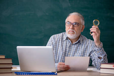 Old male teacher in the classroomの写真素材