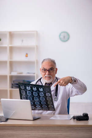 Old male doctor radiologist working at the hospitalの写真素材