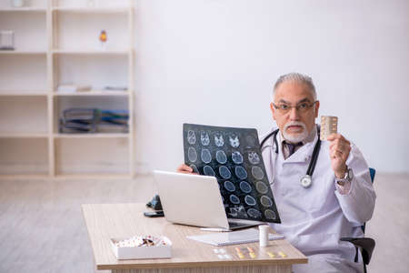 Old male doctor radiologist working at the hospitalの写真素材