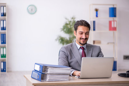 Young male employee working in the officeの写真素材