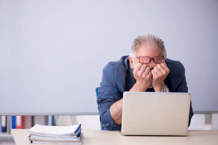 Old male teacher in tele-education conceptの写真素材