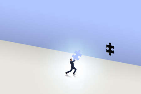 Businessman putting missing jigsaw puzzle pieceの写真素材