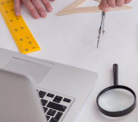 Male engineer working on drawings and blueprintsの写真素材