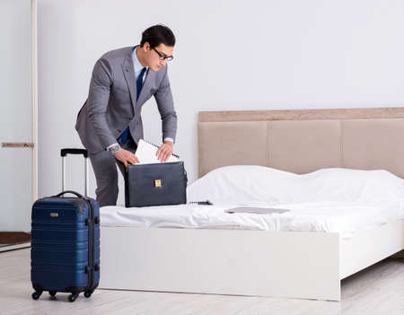 Businessman working in hotel roomの写真素材