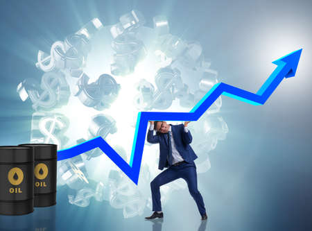 Businessman supporting oil price in business conceptの写真素材