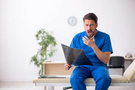 Young male doctor radiologist sitting in the clinic
