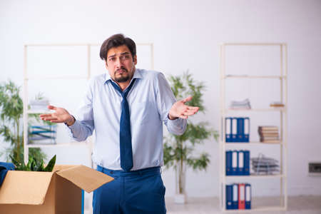 Young male employee in business relocation concept