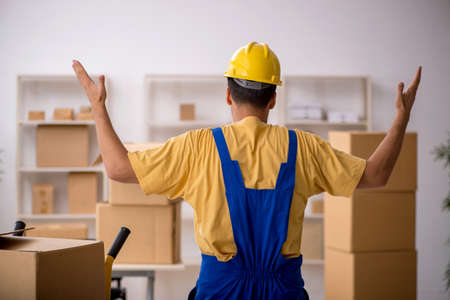 Young male contractor doing home relocation