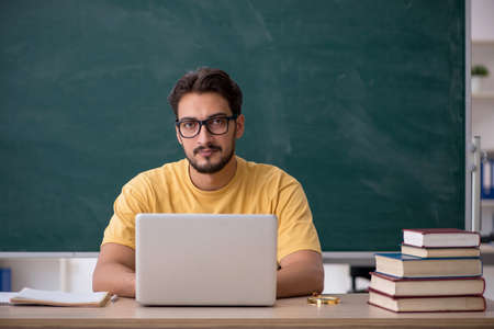 Young male student in telestudying concept