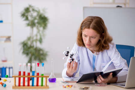 Young female chemist student studying molecular modelの写真素材