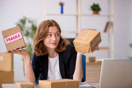 Young woman working in box delivery serviceの写真素材