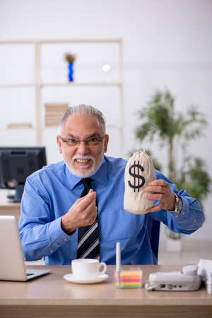 Old male employee in remuneration conceptの写真素材