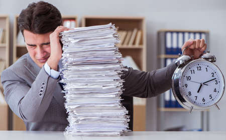 Businessman busy with paperwork in office
