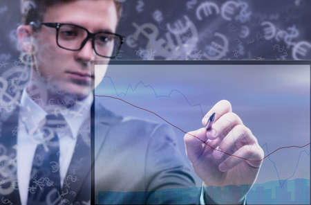 Young businessman in online trading conceptの写真素材