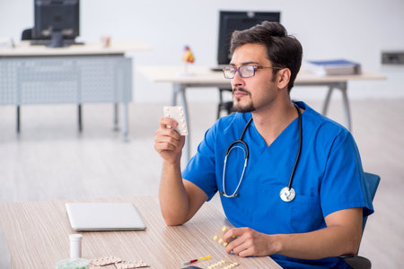 Young male doctor working in the clinicの写真素材
