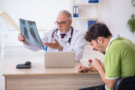 Young male patient visiting old male doctor radiologist
