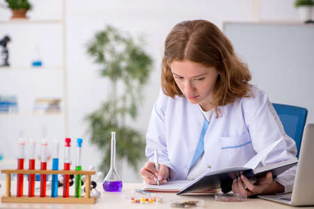 Young female chemist student working at the labの写真素材