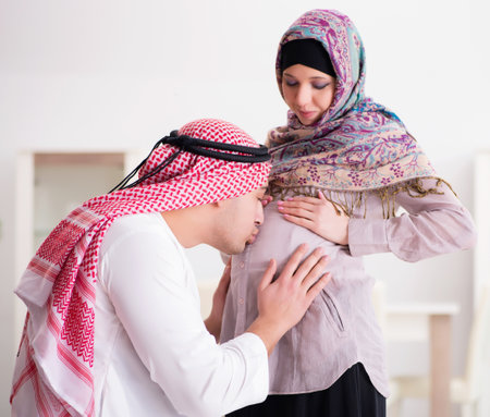 Young arab muslim family with pregnant wife expecting babyの写真素材