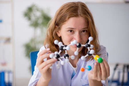 Young female chemist student studying molecular modelの写真素材