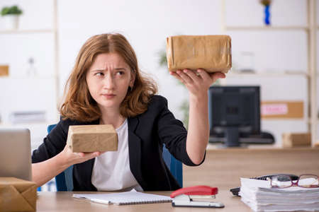 Young woman working in box delivery serviceの写真素材