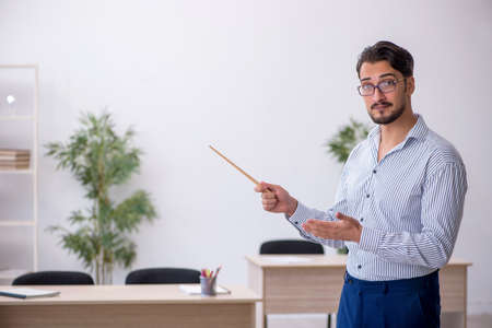 Young male teacher in the classroom