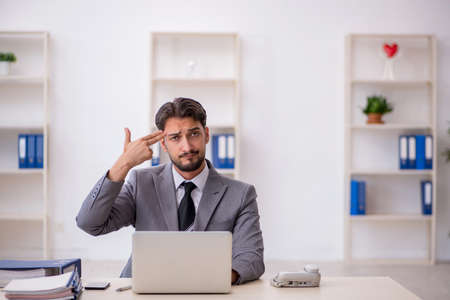Young male employee working in the officeの写真素材