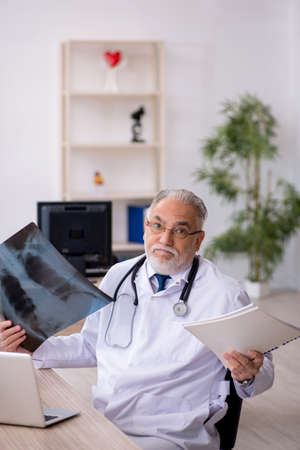 Old male doctor radiologist working in the clinicの写真素材