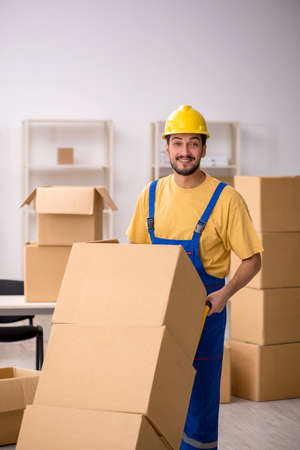 Young male contractor doing home relocationの写真素材
