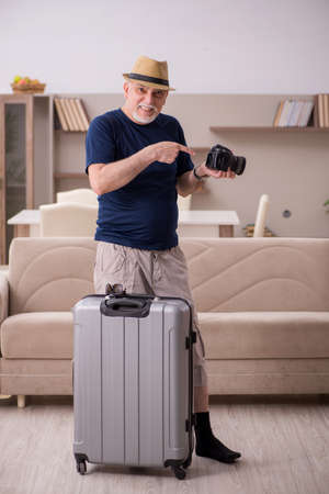 Old man preparing for trip at homeの写真素材