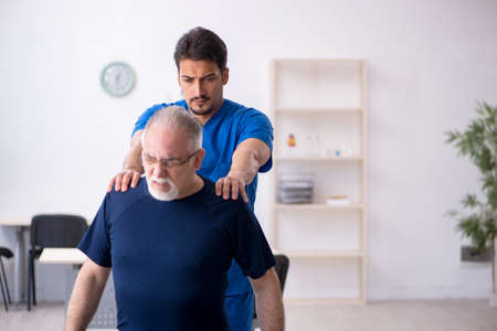 Old man visiting young male doctor