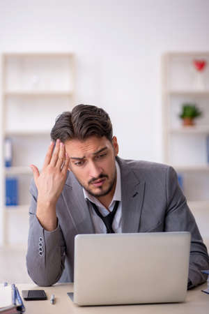 Young male employee working in the officeの写真素材