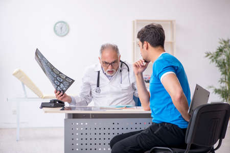 Young male patient visiting old male doctor radiologist