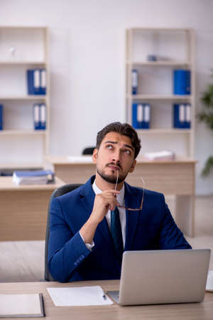 Young male employee working in the officeの写真素材