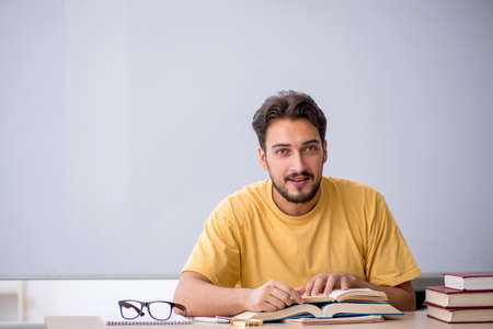 Young male student preparing for exams in the classroomの写真素材
