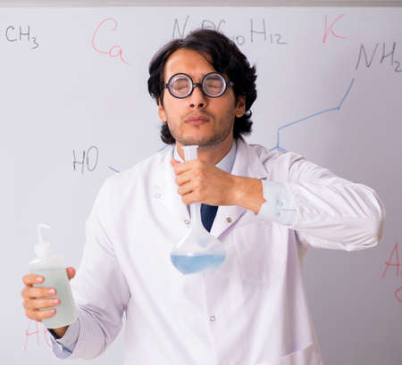 The young funny chemist in front of white boardの写真素材