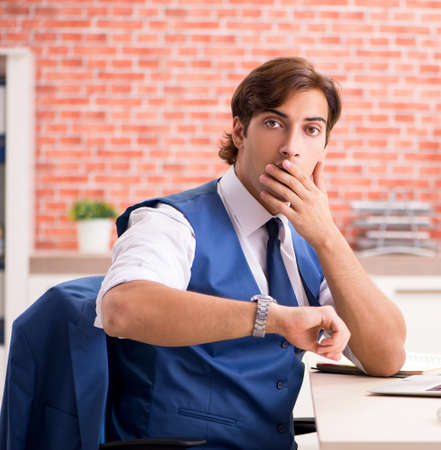 The young handsome employee working in the officeの写真素材