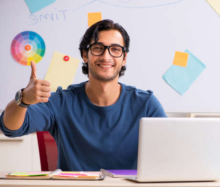 The young handsome designer working at the projectの写真素材