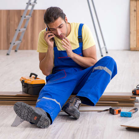 Young male contractor working indoorsの写真素材