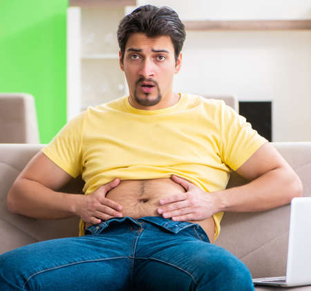 Young fat man in dieting conceptの写真素材
