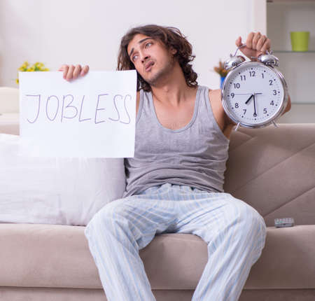 Unemployed man desperate at homeの写真素材