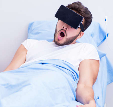 Patient in the hospital with VR glasses headsetの写真素材
